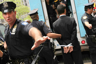 A man is led into a police van during a protest against Arizona's immigration law in New York. More than a dozen demonstrators were arrested.