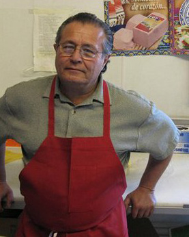 Jose Melendez, 55, poses for a photo Wednesday, April 14, 2010 at a meat shop in Flagstaff, Ariz.