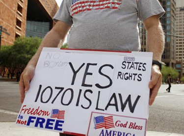 A supporter of Arizona's immigration law puts his views on display outside the U.S. District Court in Phoenix.