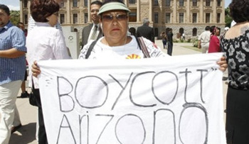 This April 29 file photo shows Josephine Nevarez, of Phoenix, holding a sign in protest of the Arizona immigration law at the Arizona Capitol in Phoenix.