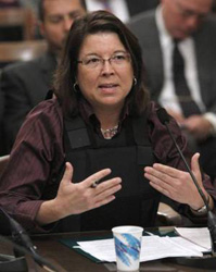 Wearing a bullet proof vest, Assemblywoman Lori Saldana, D-San Diego, testified in support of her measure that would make it illegal to openly carry a gun in public, even if it's unloaded, during a hearing of the Assembly Public Safety Committee at the Capitol in Sacramento, Calif., Tuesday, April 20, 2010. The bill was approved by the committee by a 4-2 vote. Saldana wore the vest to emphasize her point that unloaded guns pose a threat, in part because gun owners are allowed to carry ammunition and could load their weapons in seconds.