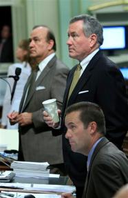 Assemblyman Steve Knight, R-Antelope Valley, seated, Assembly Minority Leader Martin Garrick, R-Solana Beach, and Assemblyman Charles Calderon, D-Montebello, watch as the votes are posted for the state budget bill at the Capitol in Sacramento, Calif., Thursday, Oct. 7, 2010. By a 54-1 vote the Assembly passed the main bill in a legislative package aimed at ending California's record budget impasse and closing a $19 billion deficit. The measure was sent to the Senate for final approval.