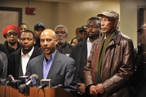 Detroit Police Chief Ralph Godbee, center, speaks at a press conference Sunday Jan. 23, 2011 about the shootings at a Detroit Police precinct Sunday afternoon, Jan. 23, 2011. A man entered the precinct and started shooting police officers, injuring four officers before he was shot and killed by return fire from the police. Detroit Mayor Dave Bing, right, attended the press conference at Sinai-Grace Hospital in Detroit, where three of the officers are being treated. 