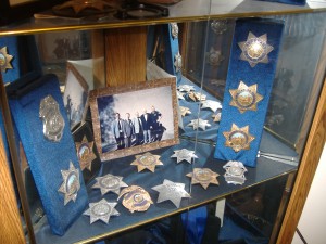 A display case encompasses the San Carlos Police Department's 85 years of history. The department closes today, and the San Mateo County Sheriff's Department will take over the city's law enforcement.