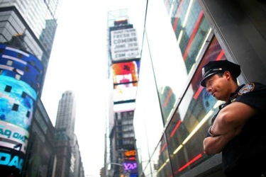 A police officer stands guard in Times Square on May 3, 2010, in New York City. The area resumed normal operations, with increased police presence, after a car bomb was discovered May 1 before it could be detonated. Credit: Yana Paskova / Getty Images