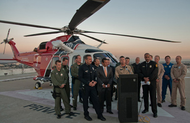 LAFD pilot Scott Davison speaks to the media about Sunday's river rescue during a press conference held atop City Hall East.