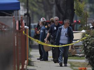 Police collect evidence during a search at the home of Lonnie David Franklin Jr., the suspected "Grim Sleeper" serial killer, on July 9. Franklin was charged with 10 counts of murder.