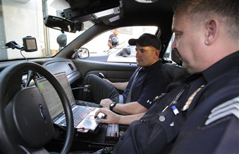 In this photo taken July 1, 2010, Los Angeles police Sgt. Bill Smith, right, talks to First Lt. Tylor Johnston, of the 2nd Battalion, 1st Marines, as they ready for a ride-along in Los Angeles. 70 Marines recently patrolled streets with the Los Angeles Police Department. It was the largest group of Marines to embed with police. The weeklong exercise involved young Marines dressed in jeans and T-shirts observing drugs busts, witnessing prostitution arrests and even following a murder case.