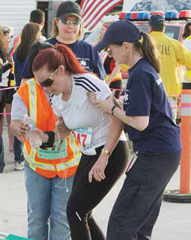 A runner competing for the Los Angeles County Coroner's Office team was exhausted and needed assistance from medical personnel.