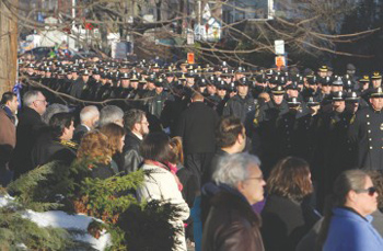 An estimated 2,000 police officers from across New England attended the wake for Officer John "Jack" Maguire, a Wilmington resident.