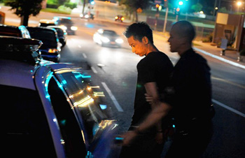 An LAPD officer arrests Larry Lo, operator of the Colorado Collective marijuana dispensary in Eagle Rock, on June 24, 2010.