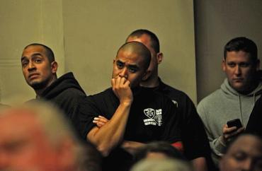 Members of the Oakland Police Department listen on June 24 as the City Council talks about laying off officers.