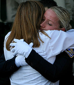 A Riverside police officer is comforted by a friend after the burial ceremony for fellow police Officer Ryan Bonaminio last week.