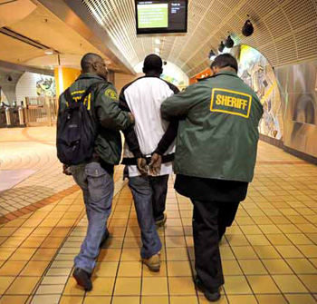 LA County Sheriff deputy Darrin Thompson and Sgt. Carlos Jaen lead a suspected drug dealer out of the North Hollywood Metro Station during a plain clothes foot patol on the LA Metro system Tuesday, October 19, 2010. Members of the LA County Sheriff's Department routinely conduct the patrols to check for fare violators and suspicious activity.