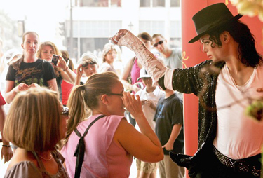 A crowd gathers around a figure of Michael Jackson on display inside the entrance to Madame Tussauds Hollywood.