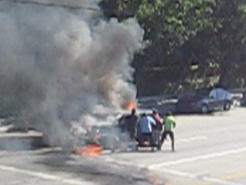 This is a still image from Sherman Oaks resident Patrick Murray's home video of Good Samaritans pulling a man from a burning classic Ford Model A after it collided with a Hyundai on Sunday, Aug. 15, 2010, at the corner of Burbank Boulevard and Vesper Avenue in Sherman Oaks. Los Angeles police would like to find the Good Samaritans so they can be thanked and honored for their service.