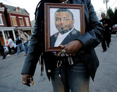 The Churchill community in Richmond, Va., gathers during a tribute for pastor Apostle Anthony L. Taylor (seen in the photo) on March 30. Taylor was killed when his vehicle was hit during a police chase.