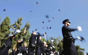 Recruits toss hats into the air in a ceremony marking completion of studies at the Los Angeles Police Academy in October, and 38 joined the LAPD. The Police Protective League wants hiring to stop.