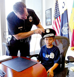 Eight-year-old Steve Huerta of Pomona tries on the chief of police hat while meeting Los Angeles Police chief Charlie Beck at his office in LAPD Headquarters June 24, 2010. Steve, who suffers from Leukimia, had his wish to meet the LAPD granted through the Make-a-wish Foundation.