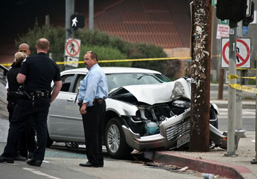 Police examine the scene where the Wilborns' vehicle crashed.