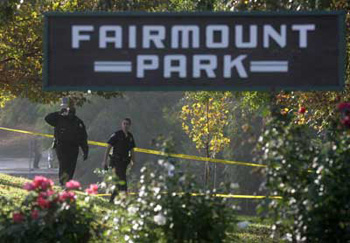 Riverside police officers examine an area where a fellow officer was gunned down. The Fairmount Park entrance from Market Street was closed much of Monday for the probe. 