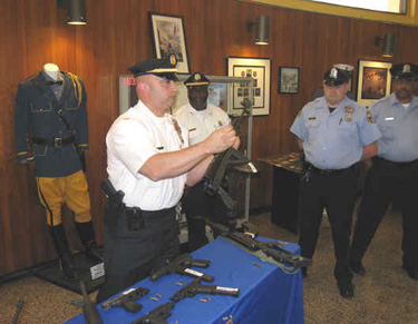 Police Lt. Vincent Testa displays weapons recovered after the shooting of Officer Kevin Livewell. Deputy Police Commissioner Richard Ross said the collection of arms was "absolutely scary."