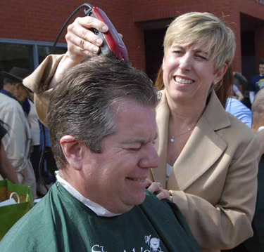 City Controller Wendy Gruel shaves the head of LAPD Lt. Greg Doyle at Fire Station 89 this morning.. Close to 200 heads of firefighters and police officers during St. Baldricks day in the annual event to raise money and pledges to support kids who have cancer and lose thier hair during treatment. Doyle's son Will has been cancer free for 8 years.