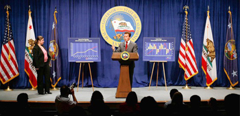 As Finance Director Ana Matosantos looks on, Gov. Arnold Schwarzenegger calls for reductions in state spending that include closing down the state's main welfare program for a savings of $1.2 billion.