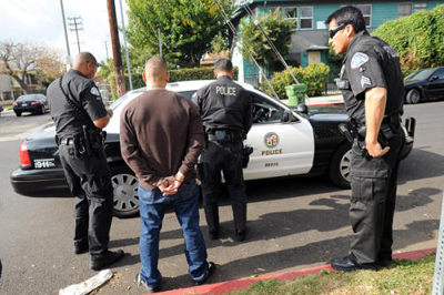 Los Angeles police officers with the H2O Unit arrest an individual after leaving the Van Nuys Courthouse. The team targets repeat DUI offenders. (Andy Holzman / Staff Photographer)