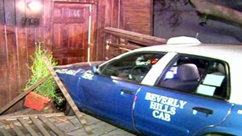 A taxi driver allegedly crashed his cab into a home after a fare dispute with tourists.