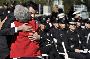 Estella Barrett, the aunt of Tina Kerbrat, hugs the fallen officers son, Craig Kerbrat. Friends, family and fellow officers of Tina Kerbrat gathered for a memorial ceremony on Feb. 11, 2011 at the North Hollywood Police Station on the 20th anniversary of her death.