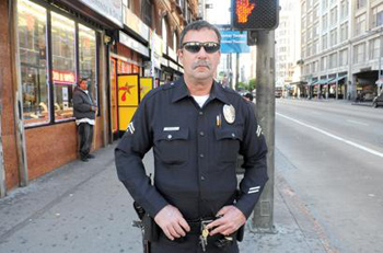 Officer Stephen Nichols, who patrols the Historic Core, will employ a zero tolerance policy for jaywalking. Drivers whose cars are stuck in intersections at red lights will also be cited. Photo by Gary Leonard.