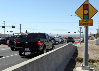 Traffic passes a red-light camera on Paseo del Norte, a busy street in Albuquerque, in March.