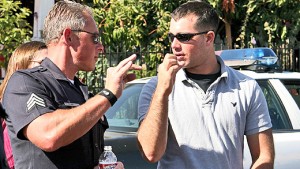 U.S. Marine Corps 1st Lt. Andrew Abbott, an Embedded Training Team company mentor, listens intently to a Los Angeles police officer in early July. Members of the Camp Pendleton based 2nd Battalion, 1st Marine Regiment conducted a series of ride-alongs with the Los Angeles Police Department Southwest Division to prepare for the troops' upcoming deployment to Afghanistan.