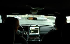 Two Vallejo police officers ride together in a car during a recent police operation. Officers will soon start riding two to a car to police Vallejo.