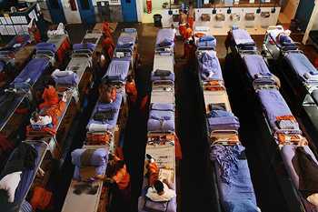 A gymnasium at the state prison in Lancaster is filled with inmates' beds.